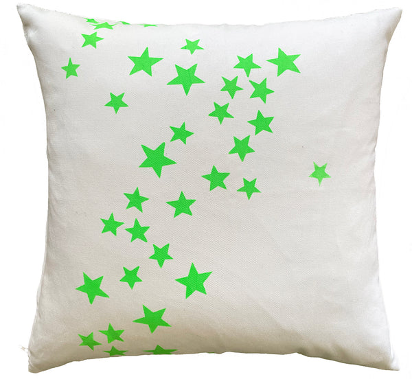 Neon green falling stars on White Denim pillow.